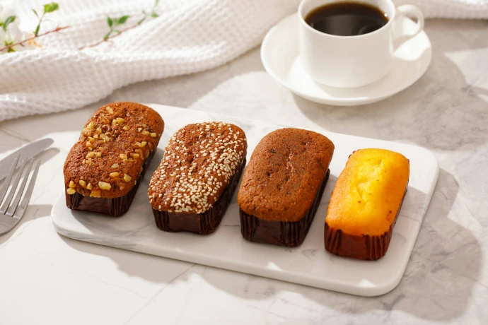a white plate topped with four different types of cakes